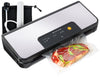 A black vacuum sealer machine sealing a steak alongside a roll of food saver bags, a black vacuum hose attachment, and black storage bag. 
