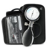 A black sphygmomanometer with an all-in-one dial, bulb, and valve design in front of a blood pressure cuff and travel case. 
