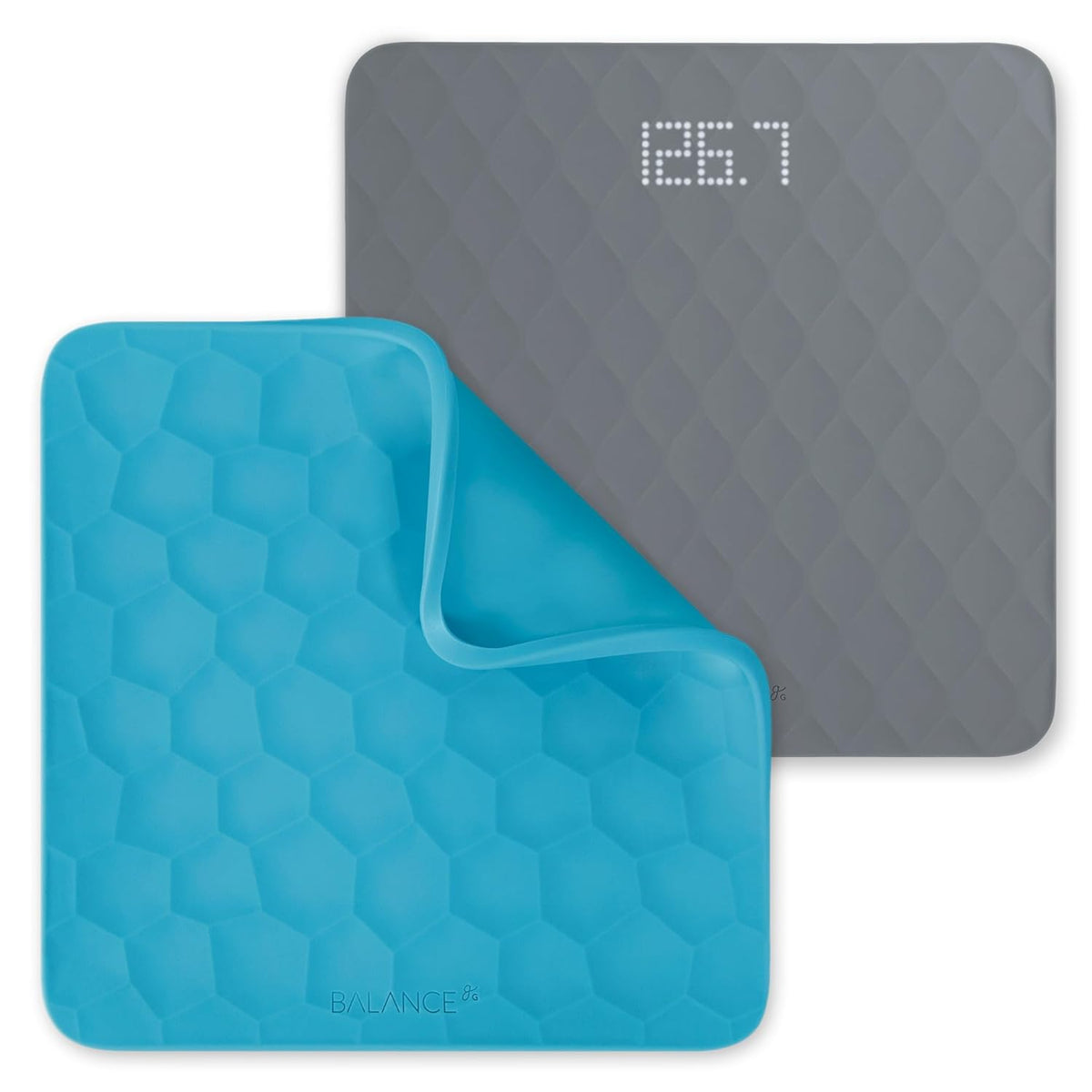Gray silicone bathroom scale next to a blue silicone cover with hexagonal pattern on a white background.
