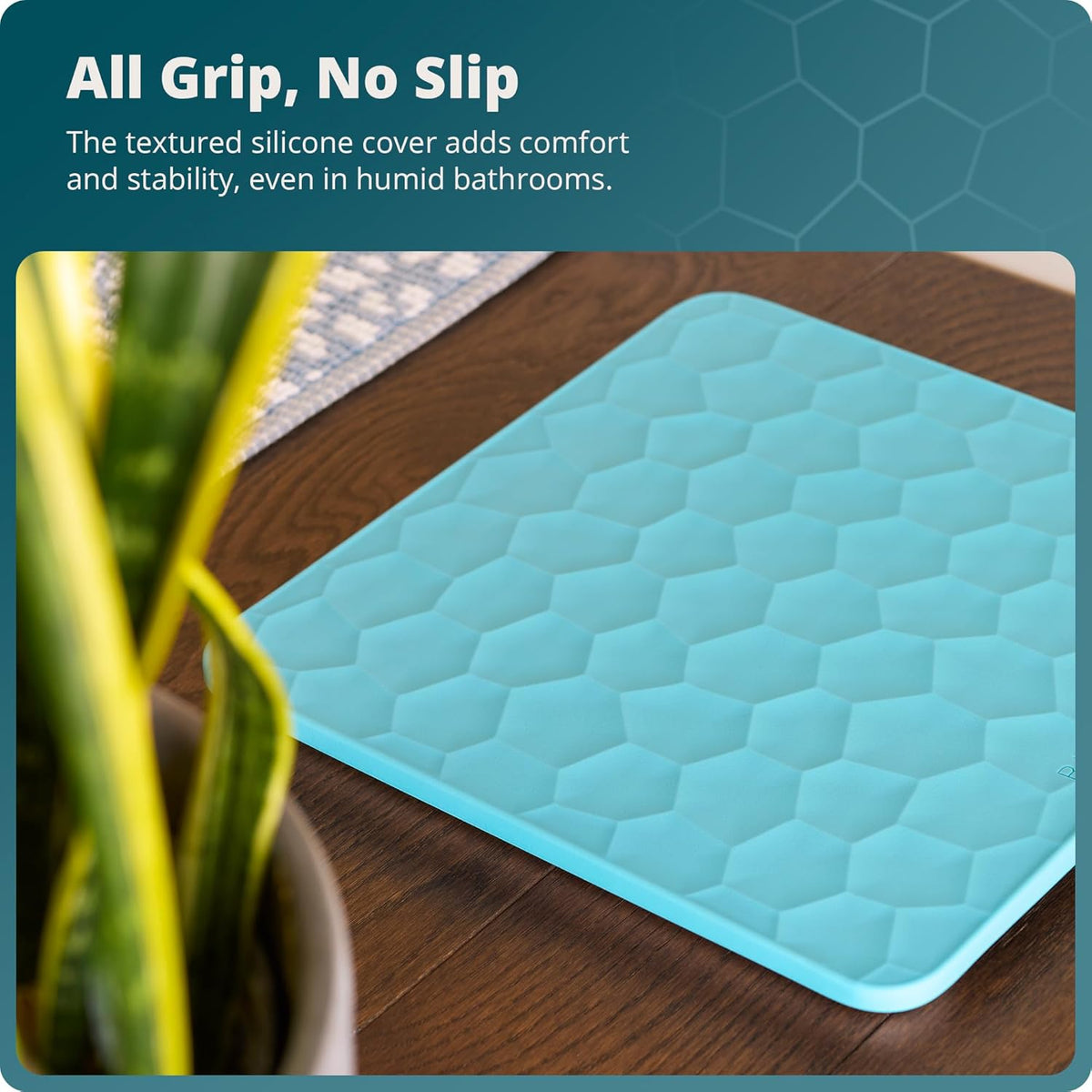 Textured silicone scale on a wooden surface with a plant and text that reads, "All Grip, No Slip: The textured silicone cover adds comfort and stability, even in humid bathrooms."