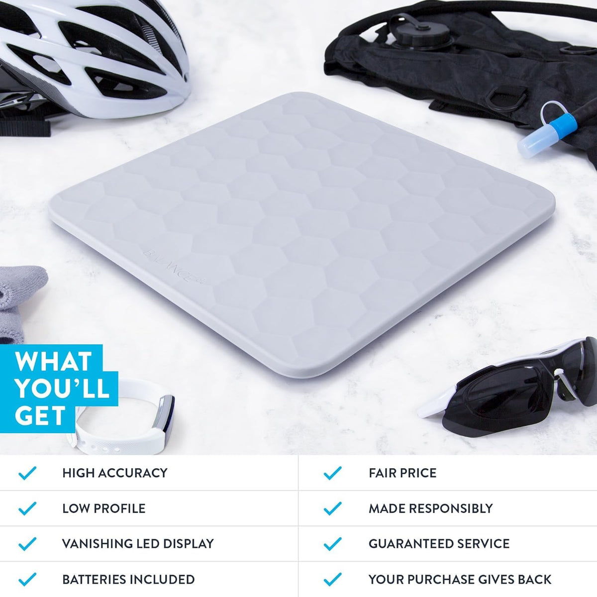 Gray silicone scale with exercise gear surrounding it on a white background. 