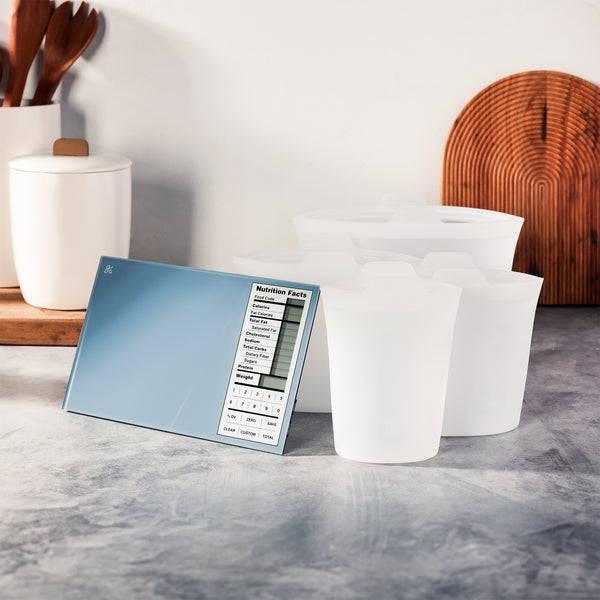 A blue nutrition scale next to clear silicone containers on a gray marble counter. 