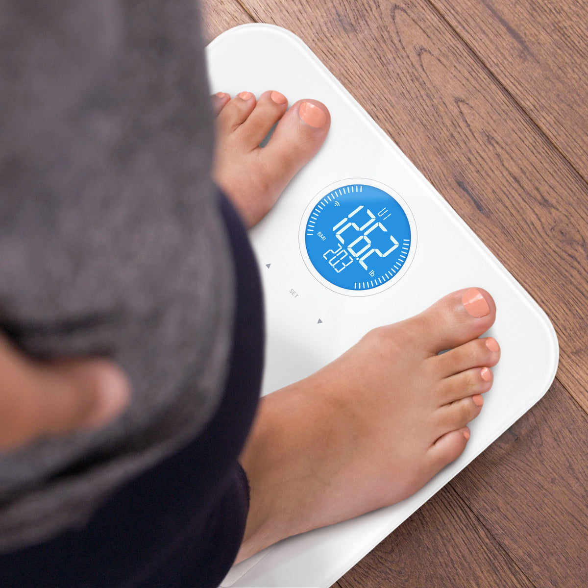 Feet standing on a White WiFi Digital Body Composition Scale 
